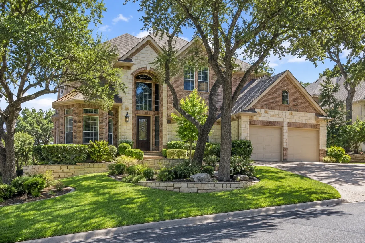 Hillside brick and limestone home in Cedar Park