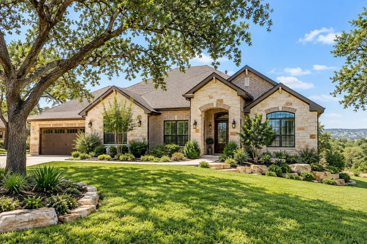Newer limestone-front home on a rolling Leander lot