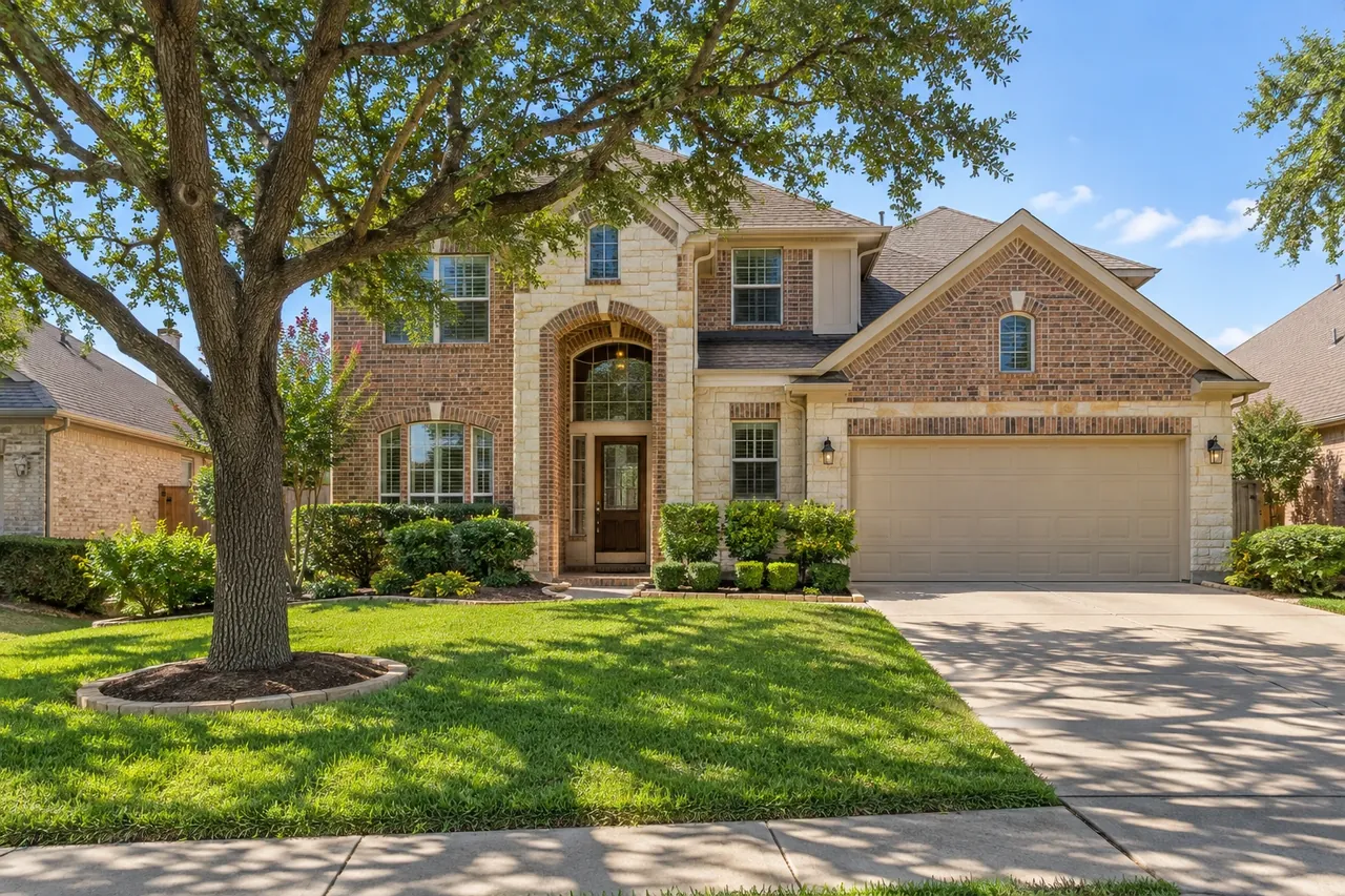 2000s brick home on a flat Pflugerville street