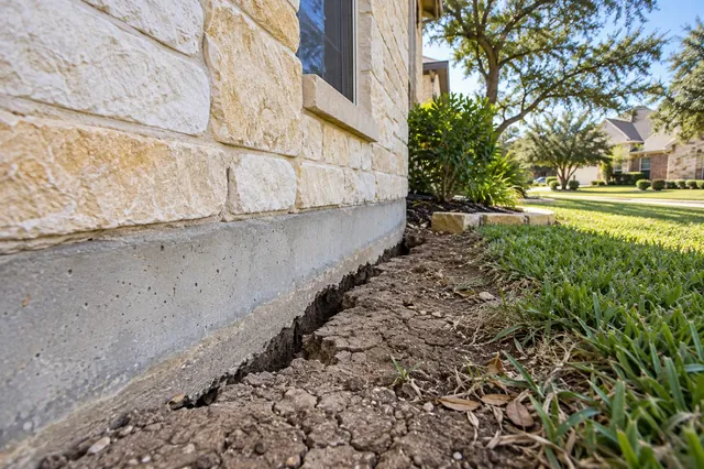A visible gap along the grade beam in late summer means the clay is drying out.