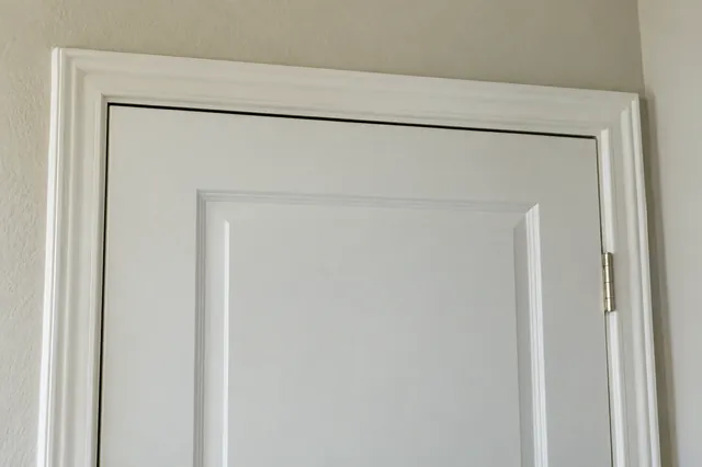 A tapered gap at the top of a door frame means the frame has racked.