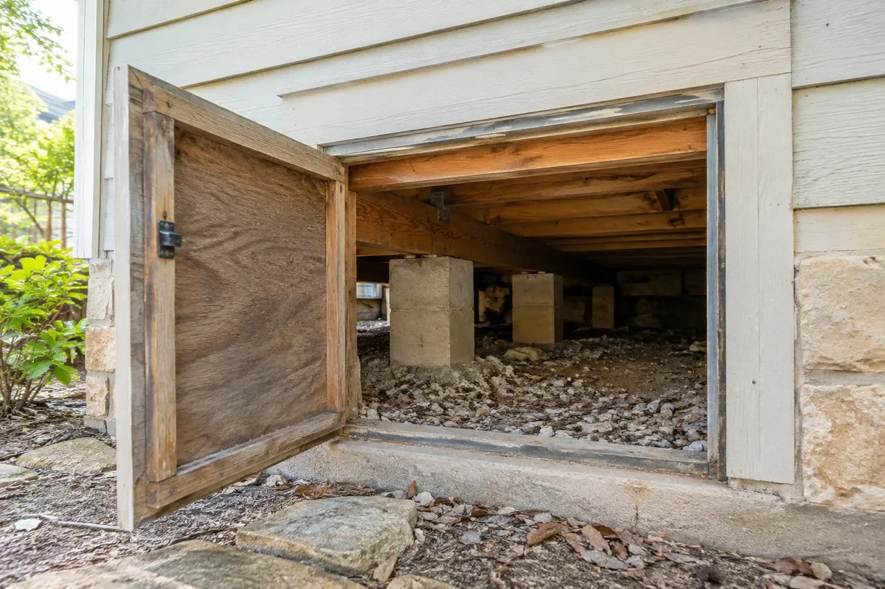 Crawl-space access under an older pier-and-beam home